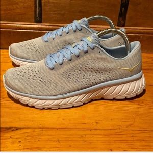 Hoka one one light blue running shoes.